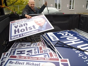 Ward 1 councillor Michael van Holst picks up some election signs on Shelborne Stree on Tuesday October 23, 2018 after winning after the first round of voting with 50.7% of the vote over Melanie O'Brien and Bud Polhill. Mike Hensen/The London Free Press/Postmedia Network