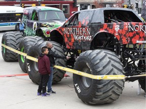 Oquinn Leger and his son Aiden check out the Northern Nightmare and Grave Digger monster trucks outside Budweiser Gardens Friday. (DEREK RUTTAN, The London Free Press)