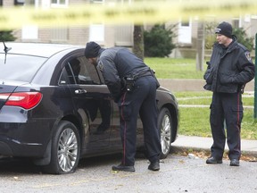 Police were busy searching for evidence in their investigation of a shooting in the parking lot of 216 Marconi Blvd. (Derek Ruttan/The London Free Press)