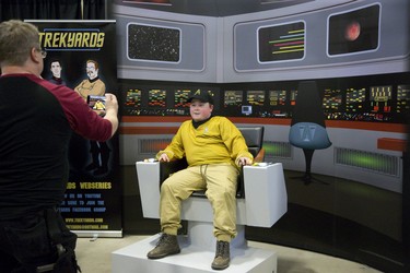 Stuart Foley takes a snapshot of twelve year old Seth Lovell sitting in a replica of the captain's chair on the bridge of the USS Enterprise in London.  The Star Trek fan was visiting London Comic Con from Glencoe with his mom Amy and sister Ayden. Foley is the host and co-creator of the Trekyards Star Trek Webseries. Derek Ruttan/The London Free Press/Postmedia Network