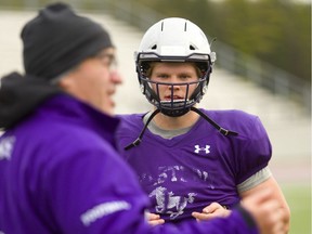 Defensive end Andrew Thurston of the Western Mustangs, listens as defensive co-ordinator Paul Gleason explains new defensive schemes for their OUA semifinal Saturday at home against the Carlton Ravens. The Mustangs who went undefeated this year nearly lost to the Ravens during their first game of the season, going into overtime for the win.   (Mike Hensen/The London Free Press)