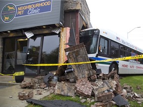 A London Transit bus sits smashed against the Neighbourhood Pet Clinic on Oxford Street between Waterloo and Colborne street in London on the morning after a late-night collision. (Derek Ruttan/The London Free Press)