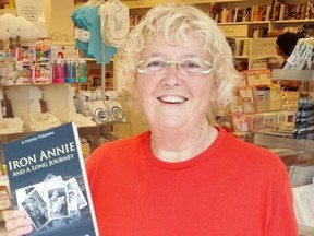 Lisa Hutchison holds up a copy of Iron Annie and a Long Journey. The book was awarded first place in the non-fiction historical/culture category by the judges for this year's PenCraft Awards for literary excellence. Handout/Postmedia Network