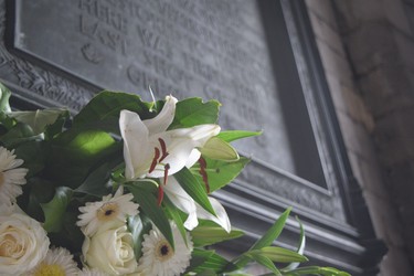 A bouquet sits at the base of a plaque in Grand Place Mons commemorating the liberation of the Belgian city by Canadian soldiers Nov. 10 and 11, 1918. (Jennifer Bieman/The London Free Press)