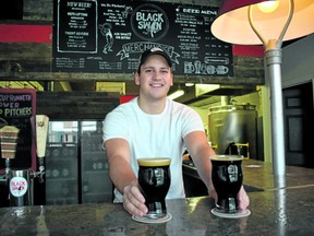 Alex Zehr presents freshly poured classic porter at the Black Swan Brewing Co. stop on Stratford's Chocolate Trail. The craft beer is made with heavy dark malt and notes of chocolate.
(BARBARA TAYLOR
The London Free Press/Postmedia News)