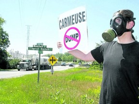 An Ingersoll resident wears a gas mask during a June 2013 protest against Walker Environmental Group’s proposal to turn a quarry near Ingersoll into a landfill. (File photo)