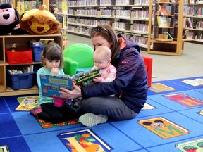 In this March 2018 file photo, Sara Hendrikx reads a book to her daughters Meredith (left) and Malayna at the Strathroy Public Library.