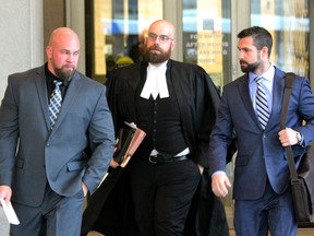 London police Const. Wesley Reeves, left, leaves the courthouse with his lawyer, Nick Cake, and associate Michael Johnson on Monday, Nov. 27, 2018. Six criminal charges against Reeves, a five-year service member, were withdrawn after he signed a peace bond. (DALE CARRUTHERS, The London Free Press)