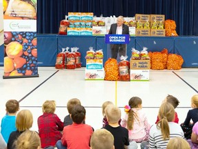 MPP Ernie Hardeman, the Minister or Agriculture, Food and Rural Affairs, stands before elementary pupils in Woodstock Friday, Nov. 23 to  announce a partnership to support the Fresh from the Farm program. (Submitted photo)