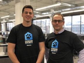 Michael DeLorenzi, president and CEO of Northern Commerce, left, and Steve Ryall, executive director of the Humane Society London and Middlesex, wear a t-shirt showing the new logo the local organization will be using moving forward. JONATHAN JUHA/THE LONDON FREE PRESS