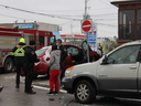 London police officers are seen at the scene of a three-vehicle collision on Adelaide Street North Wednesday morning. A vehicle jumped the curb. No major injuries were reported. JONATHAN JUHA/THE LONDON FREE PRESS