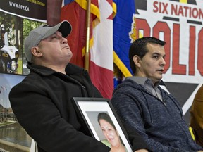 An emotional Trevor Miller holds a portrait of his sister Melissa Miller during a news conference on the Six Nations of the Grand River Territory on Thursday November 15, 2018. Melissa Miller was one of three Six Nations residents found killed in the Municipality of Middlesex Centre, near London, earlier this month. (Brian Thompson/Postmedia Network)