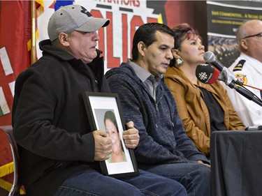 An emotional Trevor Miller holds a portrait of his sister, Melissa Miller as he pleas for someone to come forward with information, during a news conference on the Six Nations of the Grand River Territory on Thursday November 15, 2018. Melissa Miller was one of three Six Nations residents found slain in the Municipality of Middlesex Centre, near London, earlier this month. Brian Thompson/Brantford Expositor/Postmedia Network