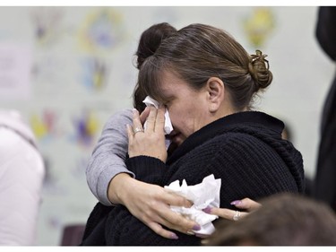 Members of the community weep during a news conference on the Six Nations of the Grand River Territory on Thursday November 15, 2018. Three Six Nations residents were found slain in the Municipality of Middlesex Centre, near London, earlier this month, and police are appealing for those with information to come forward. Brian Thompson/Brantford Expositor/Postmedia Network