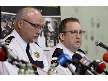 Six Nations Police acting deputy chief Darren Montour (left) listens as Det. Insp. Peter Liptrott of the Ontario Provincial Police speaks during a news conference on the Six Nations of the Grand River Territory on Thursday November 15, 2018. Three Six Nations residents were found slain in the Municipality of Middlesex Centre, near London, earlier this month, and police are appealing for those with information to come forward. Brian Thompson/Brantford Expositor/Postmedia Network