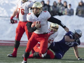 Laval University Rouge et Or quarterback Hugo Richard runs to a first down against Western Mustangs during second quarter action of the Vanier Cup final Saturday, November 24, 2018 in Quebec City. Laval won, 34-20. THE CANADIAN PRESS/Jacques Boissinot