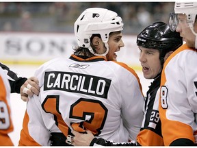 Philadelphia Flyers left wing Daniel Carcillo is restrained by referee Ian Walsh (29) in the first period against the Minnesota Wild during a preseason NHL hockey game in St. Paul, Minn., on September 25, 2010. Daniel Carcillo spoke out about his experience with hazing while a member of the OHL's Sarnia Sting, detailing how he feels Canada's hockey culture needs to change.