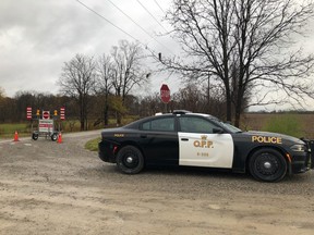 Middlesex County OPP officers at the scene near Bodkin Road and Jones Drive, near Oneida Nation of the Thames, in Middlesex Centre, where three bodies were discovered Sunday morning. (JONATHAN JUHA, The London Free Press file photo)