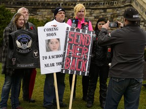 Rodney Stafford, third from left, father of Tori Stafford, poses for a photo with supporters during a 'Justice for Tori' protest on Parliament Hill in Ottawa on Friday, Nov. 2, 2018. THE CANADIAN PRESS/Sean Kilpatrick