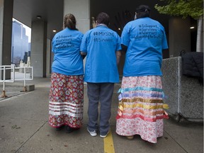 Supporters of witnesses against David Norton in the former cleric's trial and indecent and sexual assault  form a circle for smudging at the courthouse in  in London on Friday. (Derek Ruttan/The London Free Press)