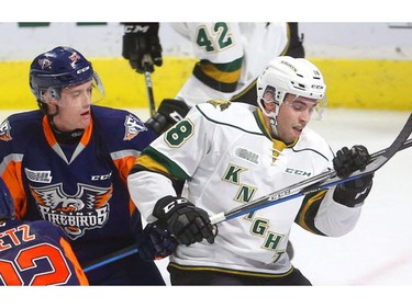 Hunter Holmes of the Flint Firebirds ties up Liam Foudy in first period action Friday night at Budweiser Gardens in London, Ont.  Photograph taken on Friday November 2, 2018.  Mike Hensen/The London Free Press/Postmedia Network