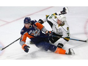 Billy Moskal of the Knights gets called for holding as he hauls down Ty Dellandrea of the Flint Firebirds in first period action Friday night at Budweiser Gardens in London, Ont.  Photograph taken on Friday November 2, 2018.  Mike Hensen/The London Free Press/Postmedia Network