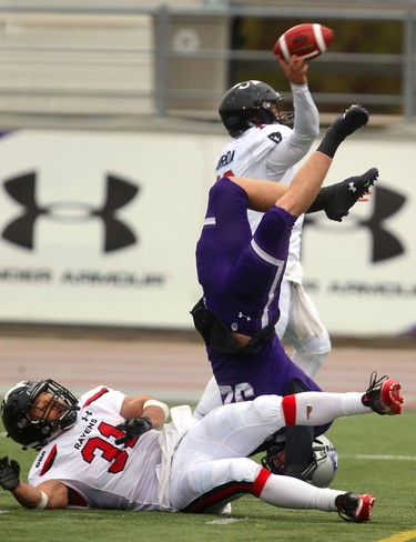 Western linebacker Fraser Sopik is upended by Carleton's Nathan Carter as he rushes their quarterback Mike Arruda during their semi-final Saturday November 3, 2018 at Td stadium.
Western won 39-13 and will move on to face Guelph next week at home for the Yates Cup.
Mike Hensen/The London Free Press/Postmedia Network