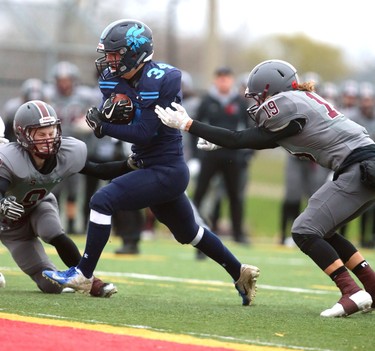 Lucas running back Nicholas Barnes gets the second Lucas touchdown between South's Kyle Comeau and Owen Apthorp with very little time left in the game making the score 14-8 (after a blocked convert) late in their TVRA Central championship game at the City Wide fields on Thursday November 8, 2018.  After a 1-1 first half where both teams made great stops, and missed field goals, South went ahead 8-1 in the fourth only to be matched immediately by Lucas making the game 8-8. A late run by Lucas Nicholas Barnes sealed the deal at 14-8 as both teams stuggled to move the ball and each team had a massive amount of penalties. Mike Hensen/The London Free Press/Postmedia Network