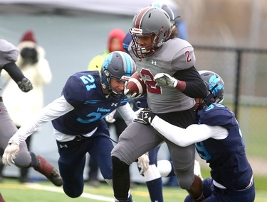 Lucas' Liam Fulton and Matt Bain converge on South running back L.J. Dyer during their TVRA Central championship game at the City Wide fields on Thursday November 8, 2018.  After a 1-1 first half where both teams made great stops, and missed field goals, South went ahead 8-1 in the fourth only to be matched immediately by Lucas making the game 8-8. A late run by Lucas'Nicholas Barnes sealed the deal at 14-8 as both teams stuggled to move the ball and each team had a massive amount of penalties. Mike Hensen/The London Free Press/Postmedia Network