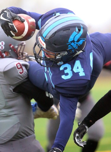 Lucas' Nicholas Barnes is lifted into the air by South's Kyle Comeau during their TVRA Central championship game at the City Wide fields on Thursday November 8, 2018.  After a 1-1 first half where both teams made great stops, and missed field goals, South went ahead 8-1 in the fourth only to be matched immediately by Lucas making the game 8-8. A late run by Lucas'Nicholas Barnes sealed the deal at 14-8 as both teams stuggled to move the ball and each team had a massive amount of penalties. Mike Hensen/The London Free Press/Postmedia Network