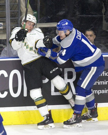 London Knight Josh Nelson takes a hit from Sudbury Wolves forward Black McConville during their game. Derek Ruttan/The London Free Press/Postmedia Network