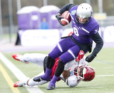 Western Mustang Francois Rocheleau is tackled by Guelph Gryphon A.J. Chase during the Yates Cup OUA championship game at TD Stadium in London, Ont. on Saturday November 10, 2018. Western won the game 63-14. Derek Ruttan/The London Free Press/Postmedia Network