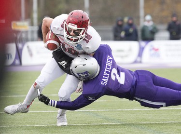 Guelph Gryphon Kade Belyk is tackled by a flying Alex Salytchev of the Western Mustangs  during the Yates Cup OUA championship game at TD Stadium in London, Ont. on Saturday November 10, 2018. Western won the game 63-14. Derek Ruttan/The London Free Press/Postmedia Network