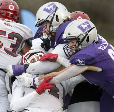 Guelph Gryphon Carter Wilson is destroyed by Dylan Griffen and Antonio Valvano of the Western Mustangs during the Yates Cup OUA championship game at TD Stadium in London, Ont. on Saturday November 10, 2018. Western won the game 63-14.in London, Ont. on Saturday November 10, 2018. Derek Ruttan/The London Free Press/Postmedia Network