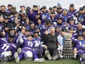 The Western Mustangs celebrate with the Yates Cup following the team's 63-14 win over the Guelph Gryphons in the Ontario University Athletics championship game at TD Stadium in London on Saturday Nov. 10, 2018. Derek Ruttan/The London Free Press