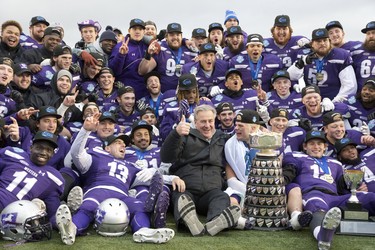 The Western Mustangs celebrate with the Yates Cup following the team's 63-14 win over the Guelph Gryphons in the  OUA championship game at TD Stadium in London, Ont. on Saturday November 10, 2018. Derek Ruttan/The London Free Press/Postmedia Network