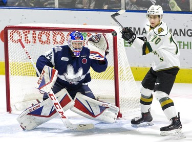 Matey Gustov of the London Knights tries but fails to tip a point shot directed at Luke Richardson of the Kitchener Rangers during  their game at Budweiser Gardens in London, Ont. on Sunday November 11, 2018. Derek Ruttan/The London Free Press/Postmedia Network