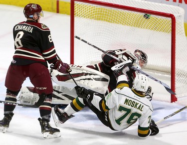 Billy Moskal of the Knights is dumped by Matt McNamara in front of Petes goaltender Hunter Jones during the first period of their game Friday November 16, 2018 at Budweiser Gardens. 
Mike Hensen/The London Free Press/Postmedia Network