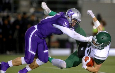 Phil Dion the middle linebacker for the Western Mustangs knocks down Joey Trumpy of the Saskatchewan Huskies in the second half of the Mitchell Bowl.
The Mustangs fought to a 17-17 tie at the half with a Mark Liegghio field goal before taking control in the second half for a convincing 47-24 win punching their tickets for Quebec City next week against Laval in the Vanier Cup. 
Photograph taken on Saturday November 17, 2018.  
Mike Hensen/The London Free Press/Postmedia Network