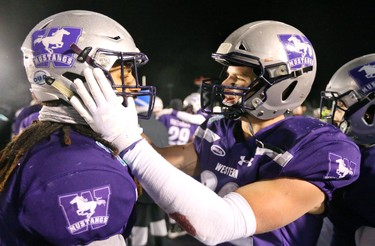 Fraser Sopik right, congratulates Cedric Joseph in the dying moments of the Mitchell Bowl as the Mustangs rang up a convincing 47-24 win against the Saskatchewan Huskies punching their tickets for Quebec City next week against Laval in the Vanier Cup. 
Photograph taken on Saturday November 17, 2018.  
Mike Hensen/The London Free Press/Postmedia Network