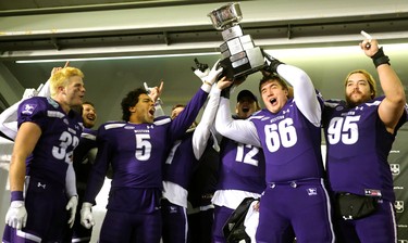 David Brown of the Mustangs holds up the Mitchell Bowl after the Mustangs rang up a convincing 47-24 win against the Saskatchewan Huskies punching their tickets for Quebec City next week against Laval in the Vanier Cup. 
Photograph taken on Saturday November 17, 2018.  
Mike Hensen/The London Free Press/Postmedia Network