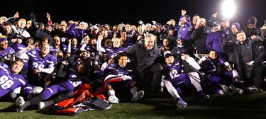 The Western Mustangs with coach Greg Marshall, flanked by Alex Taylor and game MVP Chris Merchant  pose with the Mitchell Bowl after the Mustangs rang up a convincing 47-24 win against the Saskatchewan Huskies punching their tickets for Quebec City next week against Laval in the Vanier Cup. 
Photograph taken on Saturday November 17, 2018.  
Mike Hensen/The London Free Press/Postmedia Network