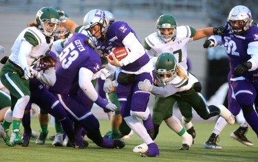 After getting beat up early by the Saskatchewan Huskies, Western quarterback Chris Merchant called his own number on a sneak to keep a drive alive in the first quarter.
The Mustangs fought to a 17-17 tie at the half with a Mark Liegghio field goal before taking control in the second half for a convincing 47-24 win punching their tickets for Quebec City next week against Laval in the Vanier Cup. 
Photograph taken on Saturday November 17, 2018. 
Mike Hensen/The London Free Press/Postmedia Network