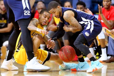 Xavier Moon of the Lightning tries for a steal from Maurice Jones Sr. of the St. John's Edge as the two quick guards fight for possession during the Lightning's season opener at Budweiser Gardens on Sunday Nov. 18, 2018. (Mike Hensen/The London Free Press)