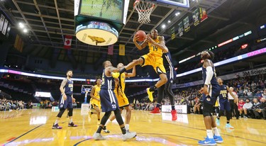 Marcus Capers of the Lightning gets fouled by Satnam Sing of the St. John's Edge as he tries for a reverse layup during the Lightning's season opener at Budweiser Gardens on Sunday Nov. 18, 2018. (Mike Hensen/The London Free Press)