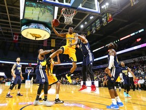 Marcus Capers of the Lightning gets fouled by Satnam Sing of the St. John's Edge as he tries for a reverse layup during the Lightning's season opener at Budweiser Gardens on Sunday Nov. 18, 2018. (Mike Hensen/The London Free Press)