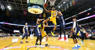 Marcus Capers of the Lightning gets fouled by Satnam Sing of the St. John's Edge as he tries for a reverse layup during the Lightning's season opener at Budweiser Gardens on Sunday Nov. 18, 2018. (Mike Hensen/The London Free Press)