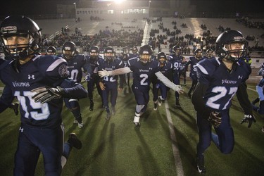 Lucas Vikings storm the field after defeating CCH 28-3 to win the junior football championship at TD Stadium in London. Derek Ruttan/The London Free Press/Postmedia Network