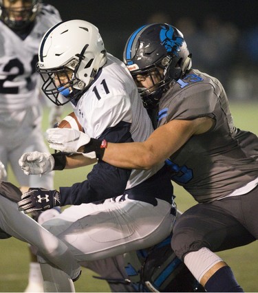 Quinn Brown of CCH is tackled by Siwon Lee of Lucas during the WOSSA senior football championship game at TD Stadium in London. Derek Ruttan/The London Free Press/Postmedia Network