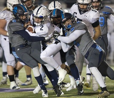 Ethan Chambers of CCH is brought down by of Lucas defenders Will Adam (left) and Jake Hart during the WOSSA senior football championship game at TD Stadium in London. Derek Ruttan/The London Free Press/Postmedia Network